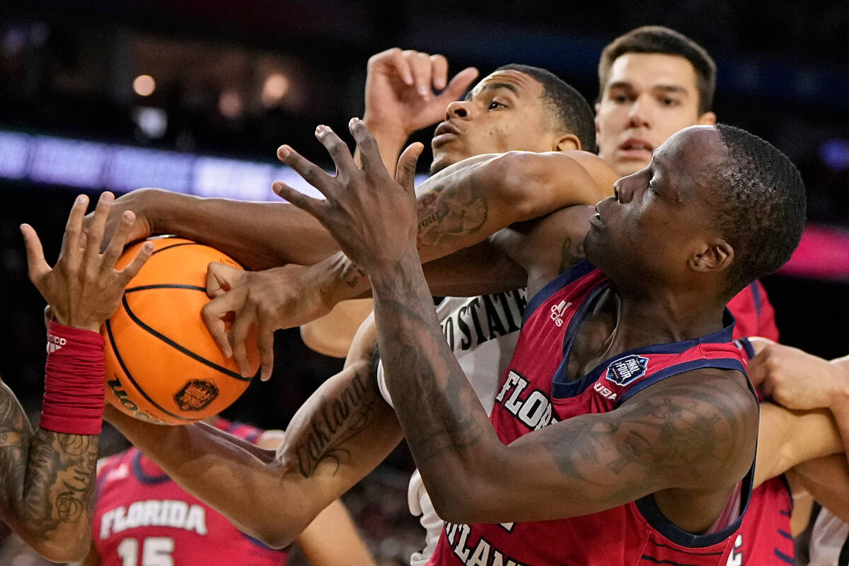 San Diego State forward Keshad Johnson vies for the ball with Florida Atlantic guard Johnell Da ...
