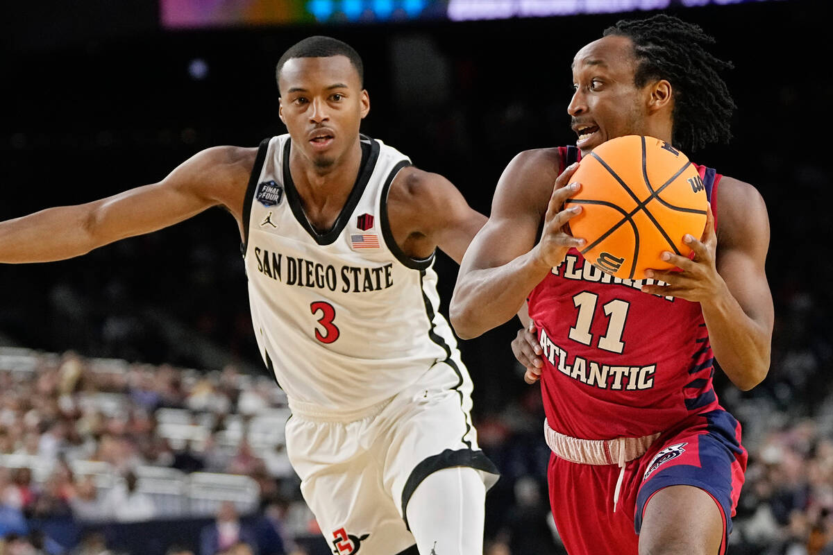 Florida Atlantic guard Michael Forrest drives to the basket past San Diego State guard Micah Pa ...