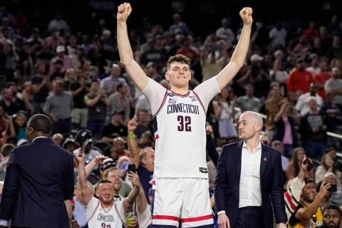 Connecticut center Donovan Clingan celebrates after their win against Miami in a Final Four col ...