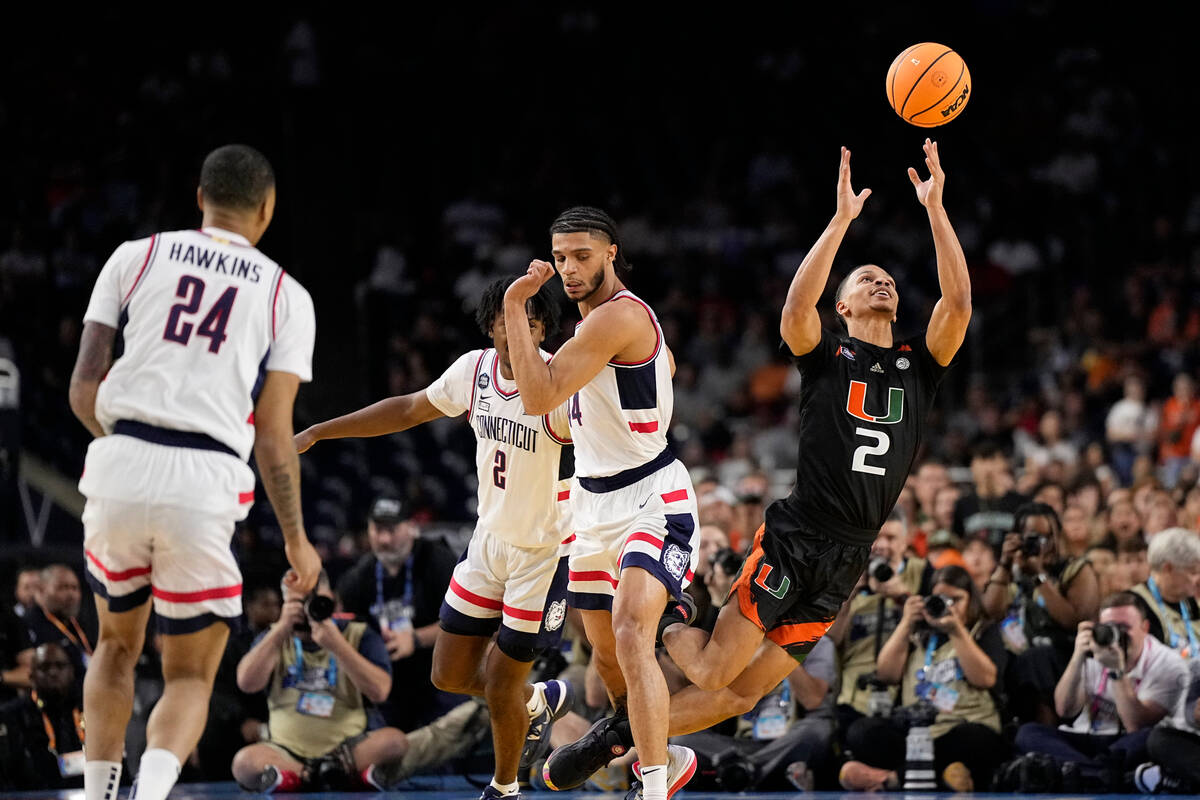 Miami guard Isaiah Wong passes against Connecticut during the first half of a Final Four colleg ...