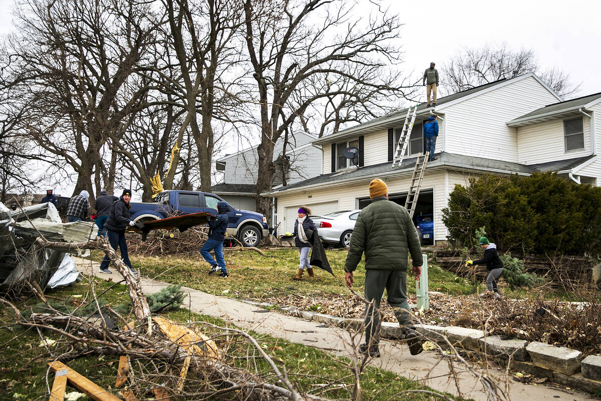 Meghann Foster, mayor of Coralville, Iowa, bottom right, works with community members to clean ...
