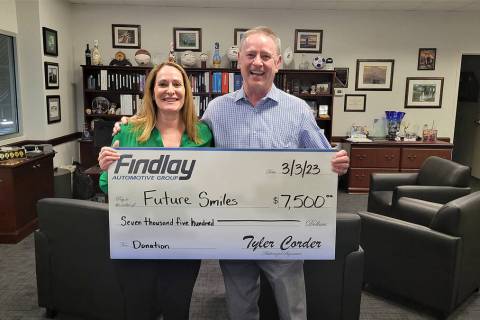 Tyler Corder, right, CFO of Findlay Automotive, presents a donation check to Christine Kenney, ...