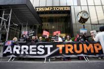 FILE - Protesters gather outside Trump Tower on Friday, March 31, 2023, in New York. Former Pre ...