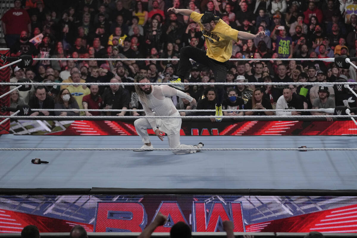 File - Wrestler Logan Paul, right, kicks Seth "Freakin" Rollins during the WWE Monday ...