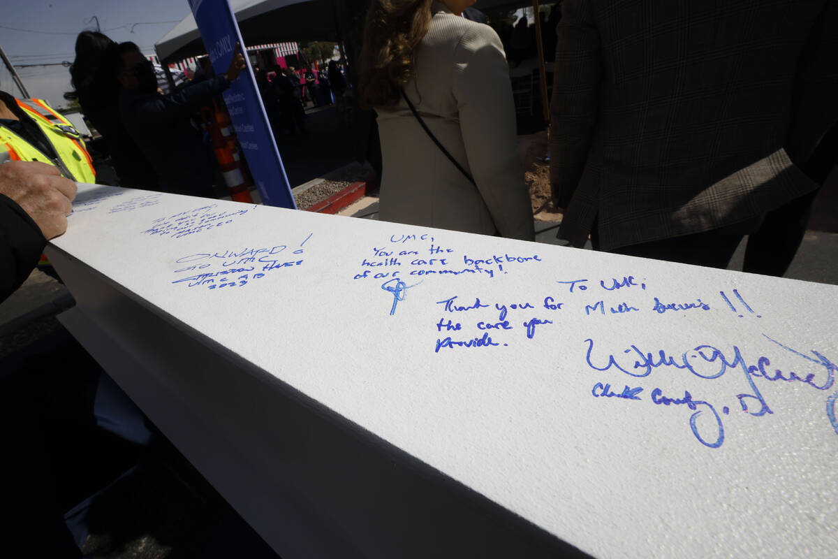 An attendee signs a beam Monday, April 3, 2023, during a groundbreaking ceremony for the ReVITA ...