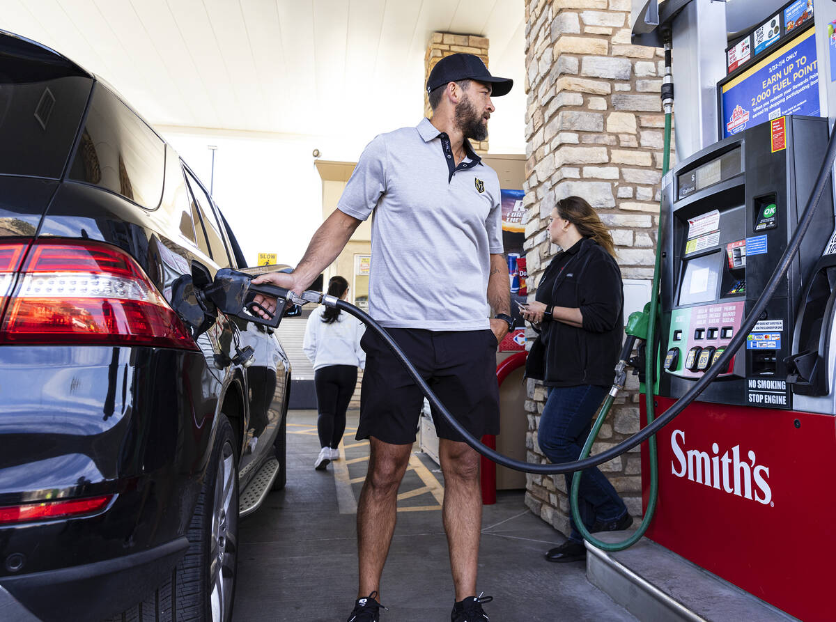 Former Knights defenseman Deryk Engelland pumps free gas to a customer at Smith’s Market ...