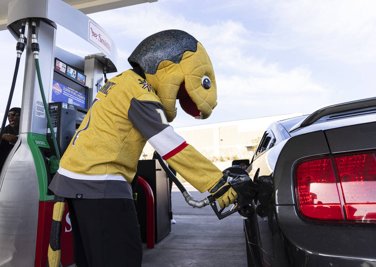Golden Knights mascot Chance pumps free gas to a customer at Smith’s Marketplace, on Fri ...