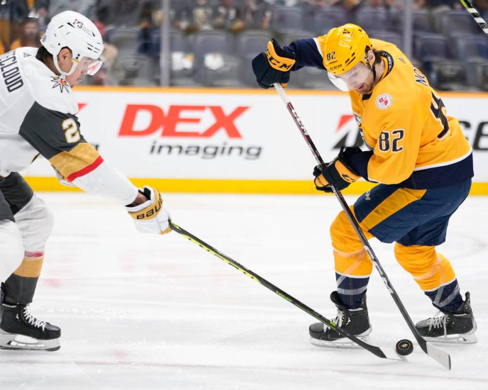Vegas Golden Knights defenseman Zach Whitecloud (2) takes the puck away from Nashville Predator ...