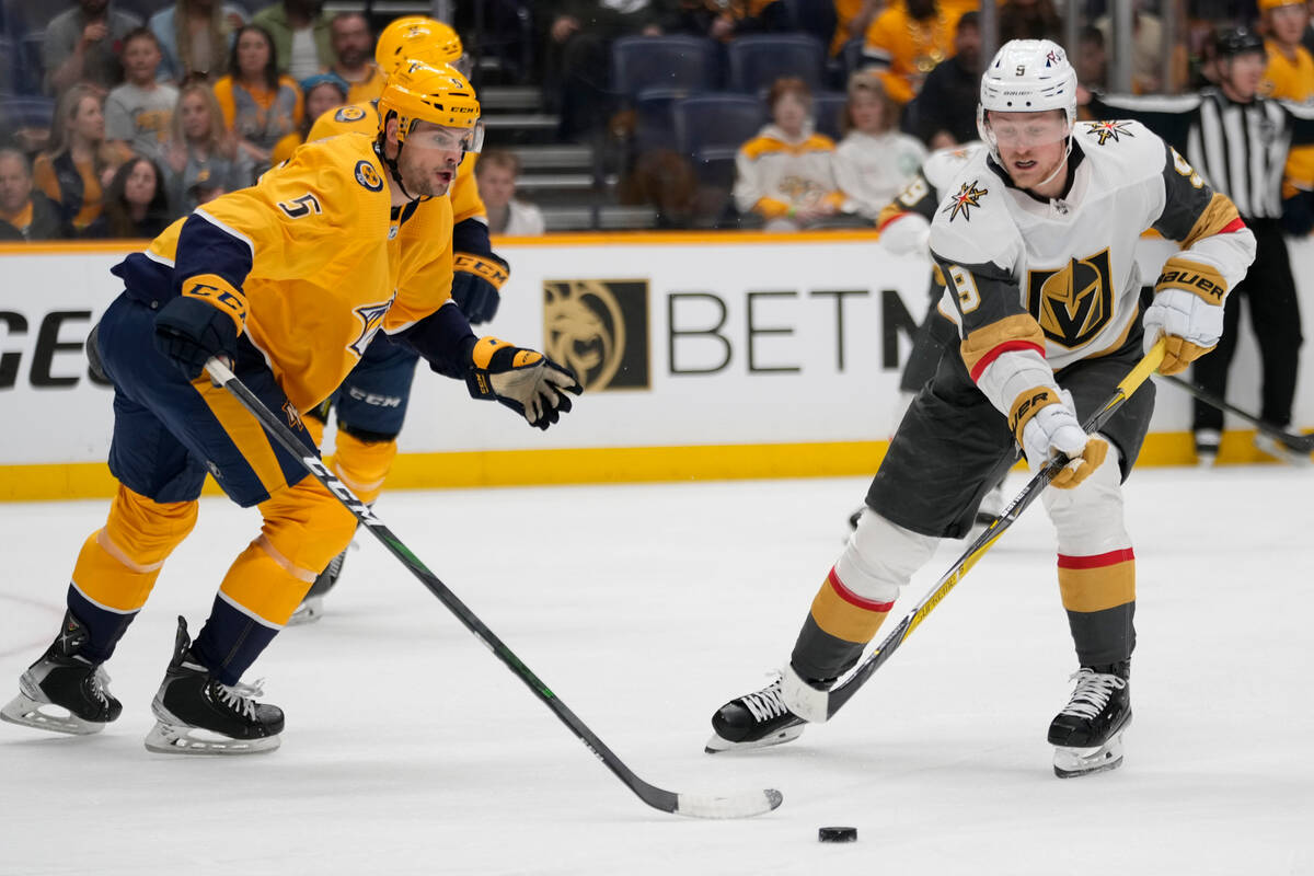 Nashville Predators defenseman Kevin Gravel (5) defends against Vegas Golden Knights center Jac ...