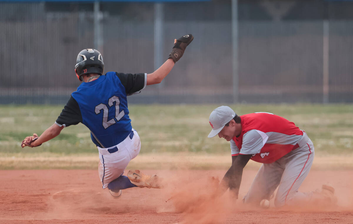 Desert Pines' Zachary Perez (22) steals second base against Doral Academy's Kainoa Paul (4) dur ...