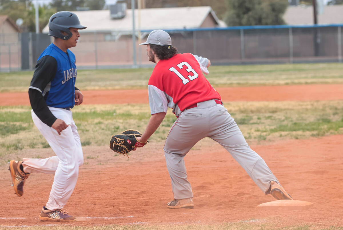 Desert Pines' Gilbert Quintero (15) gets forced out by Doral Academy's Garrett Foster (13) at f ...