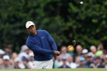 Tiger Woods hits to the 15th green during a practice for the Masters golf tournament at Augusta ...