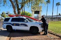 This photo shows a Phoenix police officer strapping down a 15-foot red spoon to his police crui ...