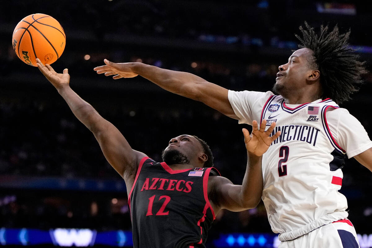 Connecticut guard Tristen Newton (2) blocks a shot by San Diego State guard Darrion Trammell du ...