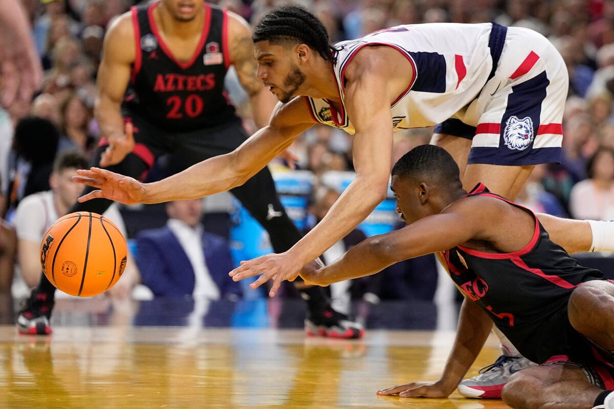 Connecticut guard Andre Jackson Jr., top, vies for the ball with San Diego State guard Lamont B ...