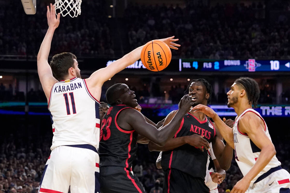 Connecticut forward Alex Karaban (11) knocks the ball away from San Diego State forward Aguek A ...