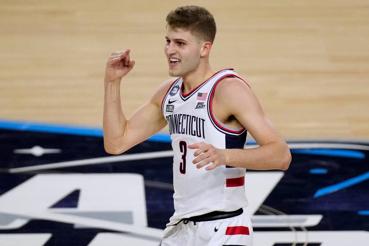 Connecticut guard Joey Calcaterra celebrates after making a basket during the first half of the ...