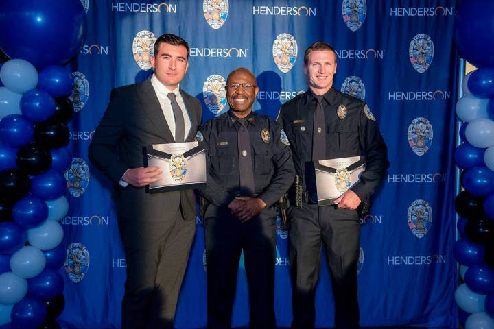 Henderson Interim Police Chief Michael Blow (center) stands with officers Ramon Martin del Camp ...