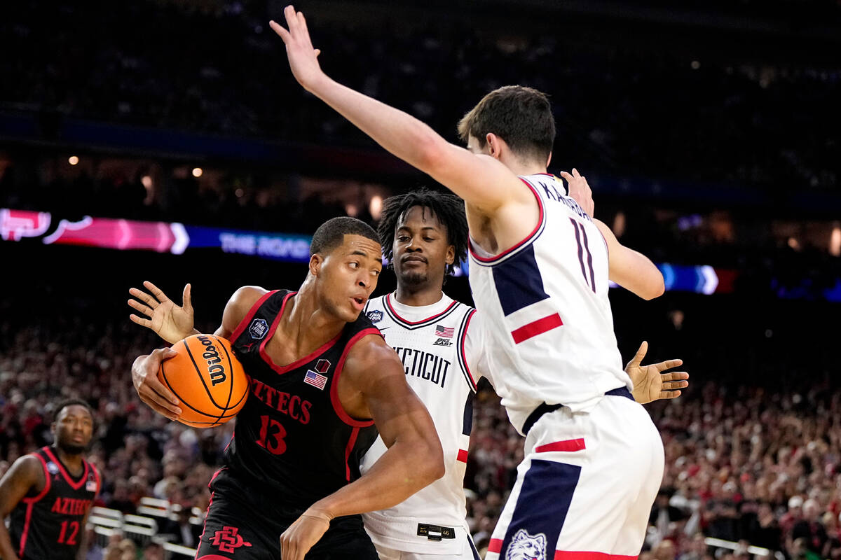 San Diego State forward Jaedon LeDee (13) drives to the basket past Connecticut guard Tristen N ...
