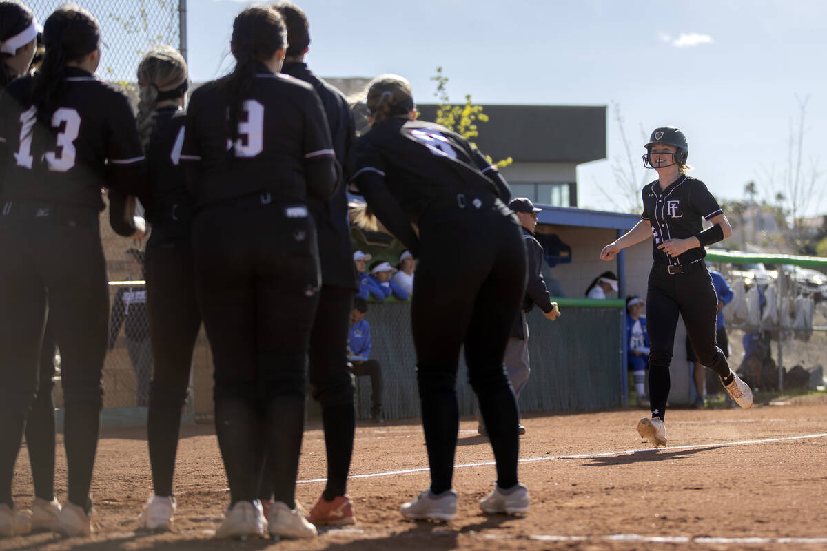 Faith Lutheran’s Savannah Moore is congratulated by her team after hitting a home run du ...