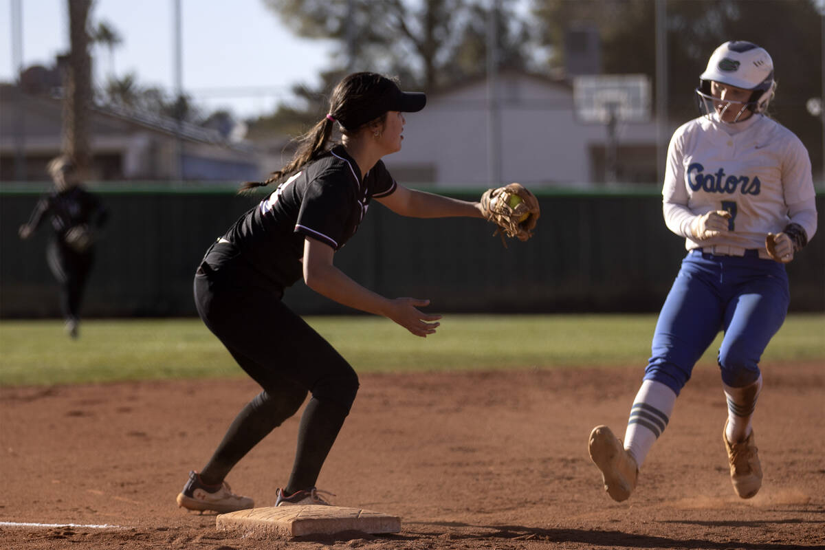 Faith Lutheran’s Averi O reaches to out Green Valley’s Aspyn Beattie at third bas ...