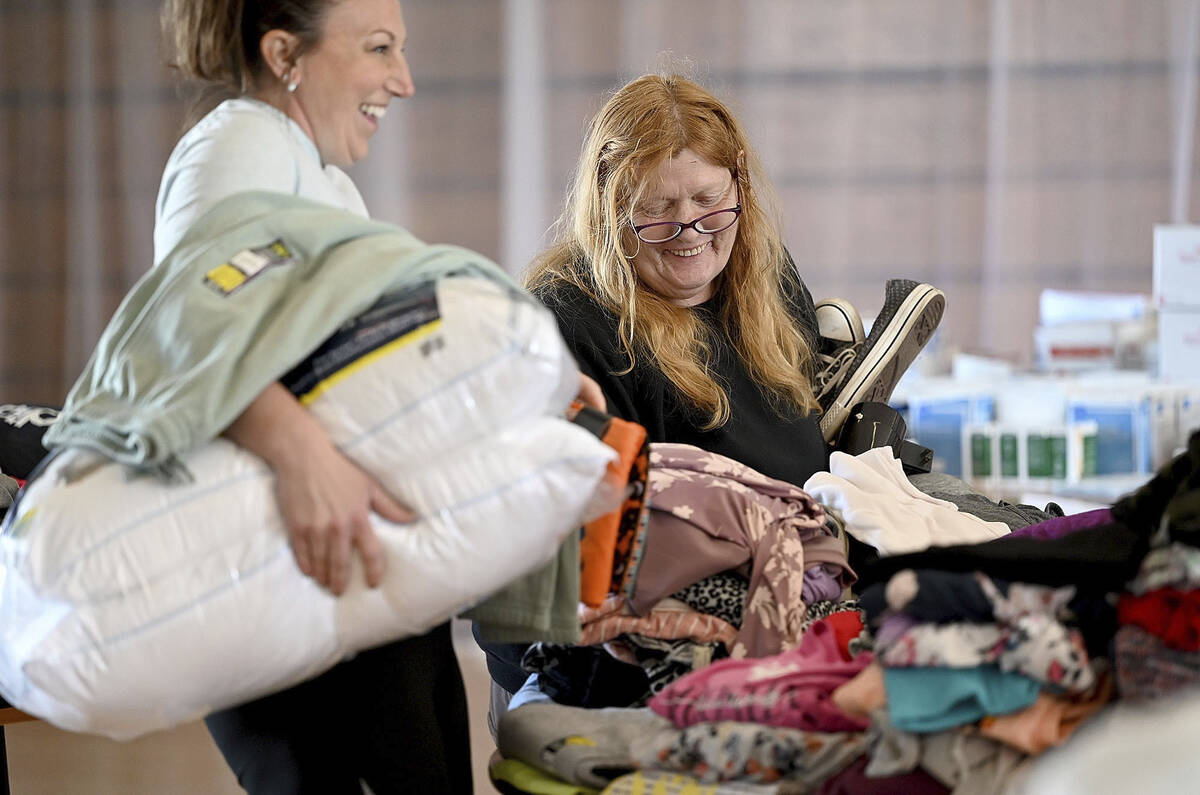 Pam Browne, right, laughs with volunteer Jamie Martin, as they pick out clothing at the Sulliva ...