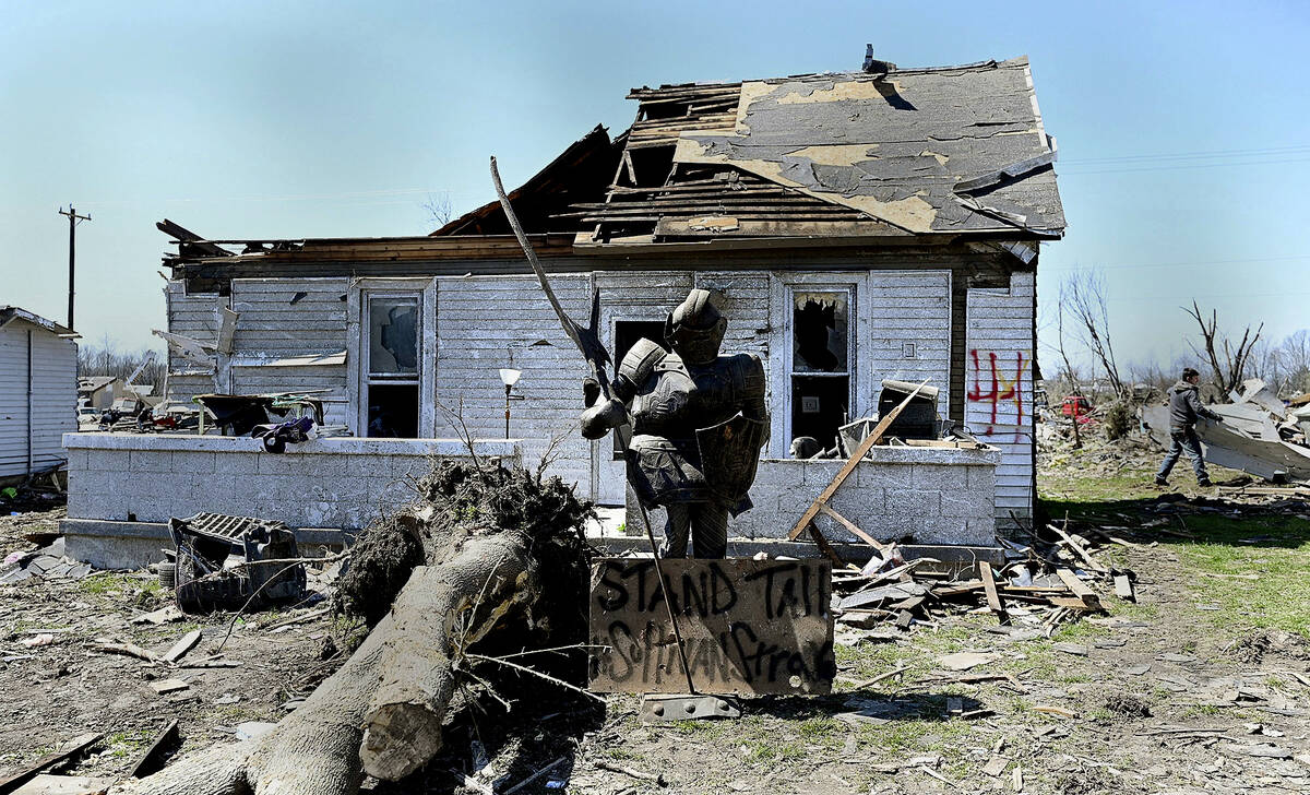 A statue of a knight stands in one of the city's neighborhoods that was damaged by a recent tor ...