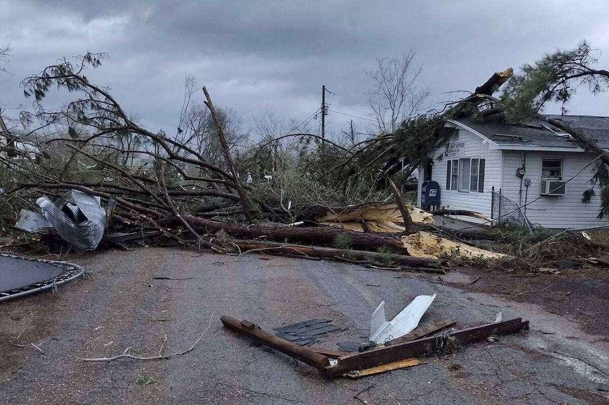 Debris covers the ground as homes are damaged after severe weather in Glen Allen, Mo., on Wedne ...