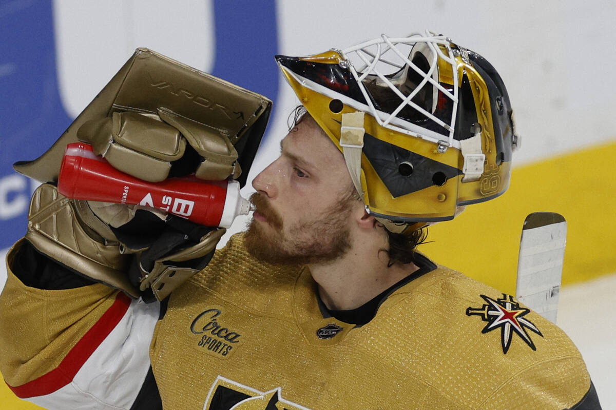 Golden Knights goaltender Laurent Brossoit (39) drinks water during a timeout in the second per ...
