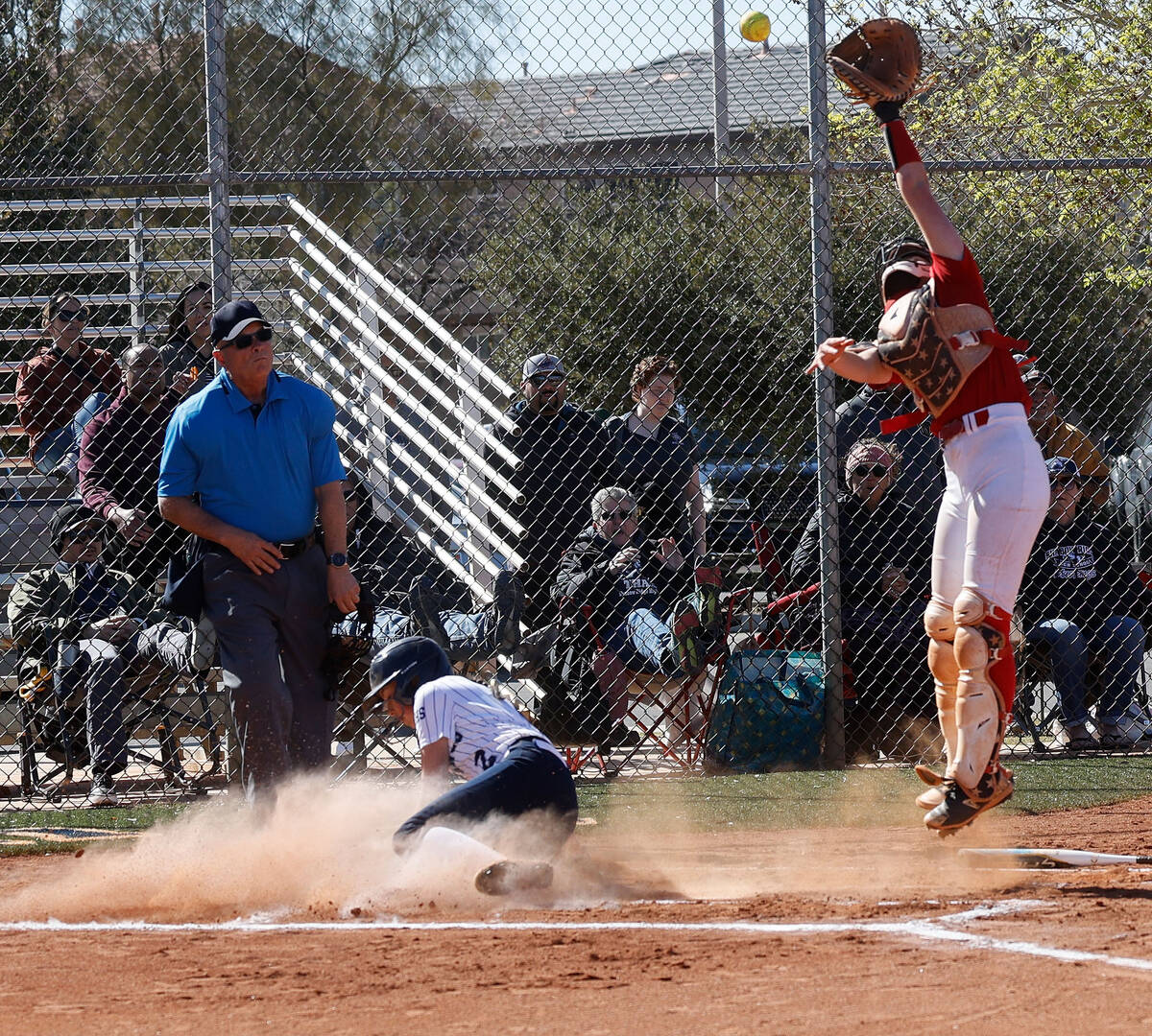 Shadow Ridge's Carmela Garganese (2) slides safely into home plate to score as Liberty catcher ...