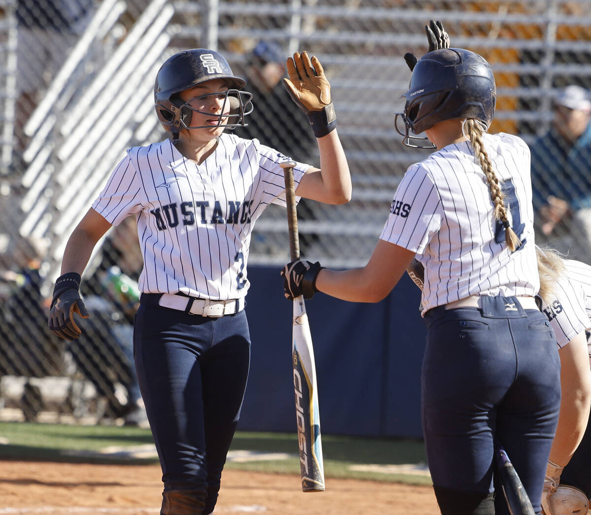 Shadow Ridge's Carmela Garganese (2) gets a high-five from her teammate Josslin Law (4) after s ...