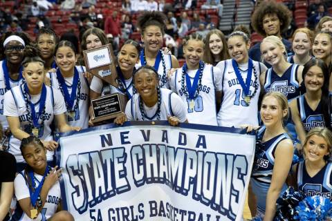 Centennial poses for photos after winning the Class 5A girls high school basketball state champ ...