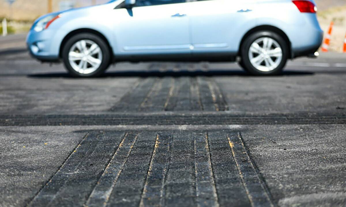 A motorist drives over a newly installed safety transverse rumble strip designed to deter trick ...