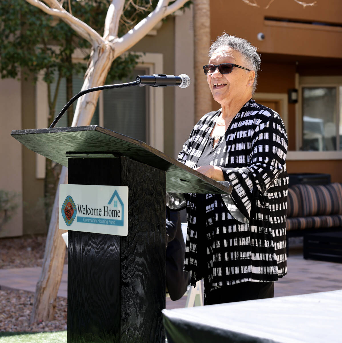 Resident Carmen Campione, 70, speaks during a ceremony at Ensemble Senior Apartments in Las Veg ...