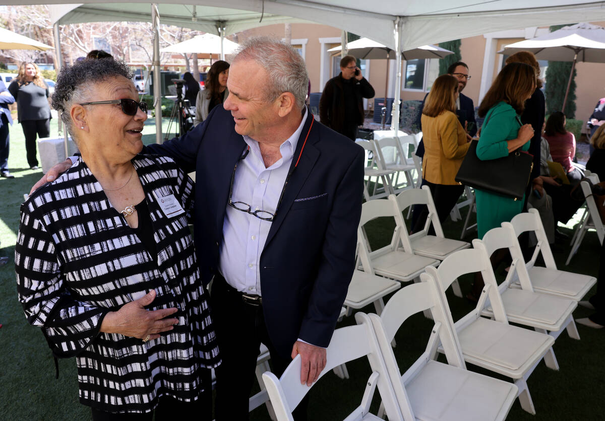 Resident Carmen Campione, 70, and developer Alan Molasky mingle during a signing ceremony at En ...