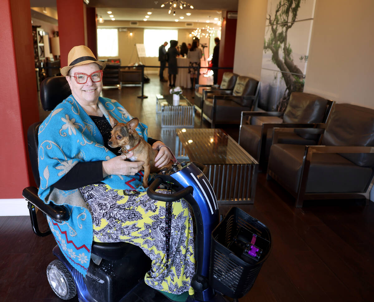 Resident Marie Bartman, 72, and her dog Penny during a signing ceremony at Ensemble Senior Apar ...