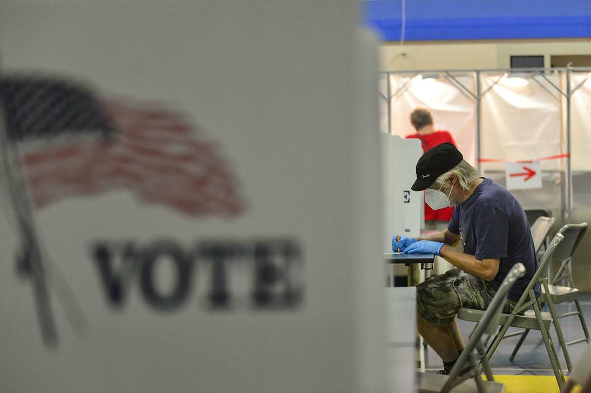 FILE - Bill Hurley, of Chesterfield, N.H., fills out his ballot at the Chesterfield, N.H., poll ...