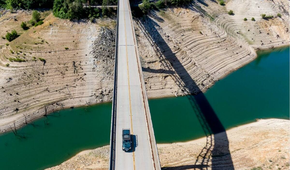 A car crosses Enterprise Bridge over Lake Oroville's dry banks on May 23, 2021, in Oroville, Ca ...