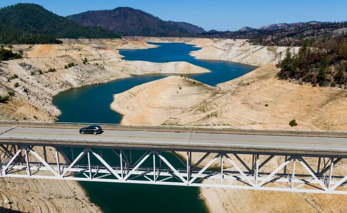 A car crosses Enterprise Bridge over Lake Oroville's dry banks on May 23, 2021, in Oroville, Ca ...