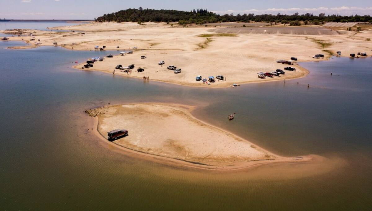 A vehicle is parked on a newly revealed piece of land due to receding waters at the drought-str ...