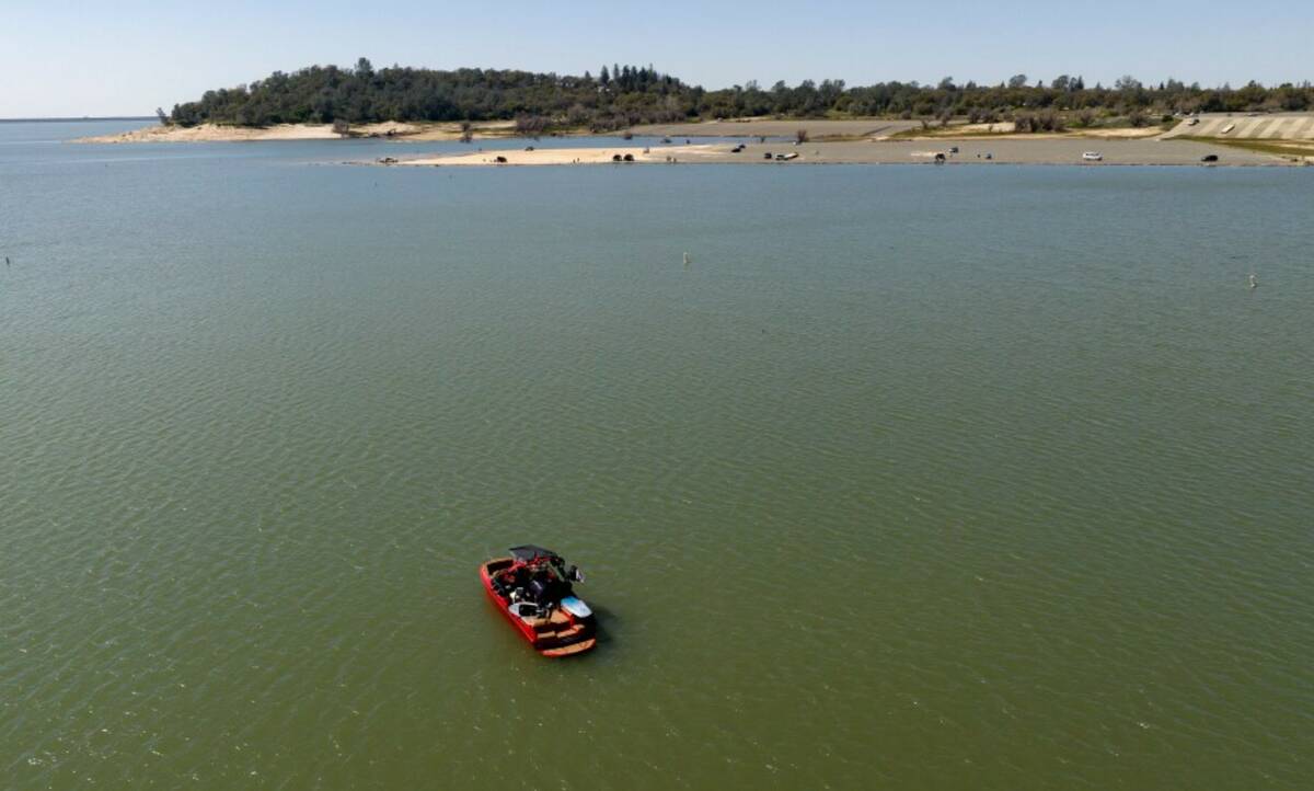 In an aerial view, a boat floats in the Granite Bay area of Folsom Lake, in Granite Bay, Calif. ...