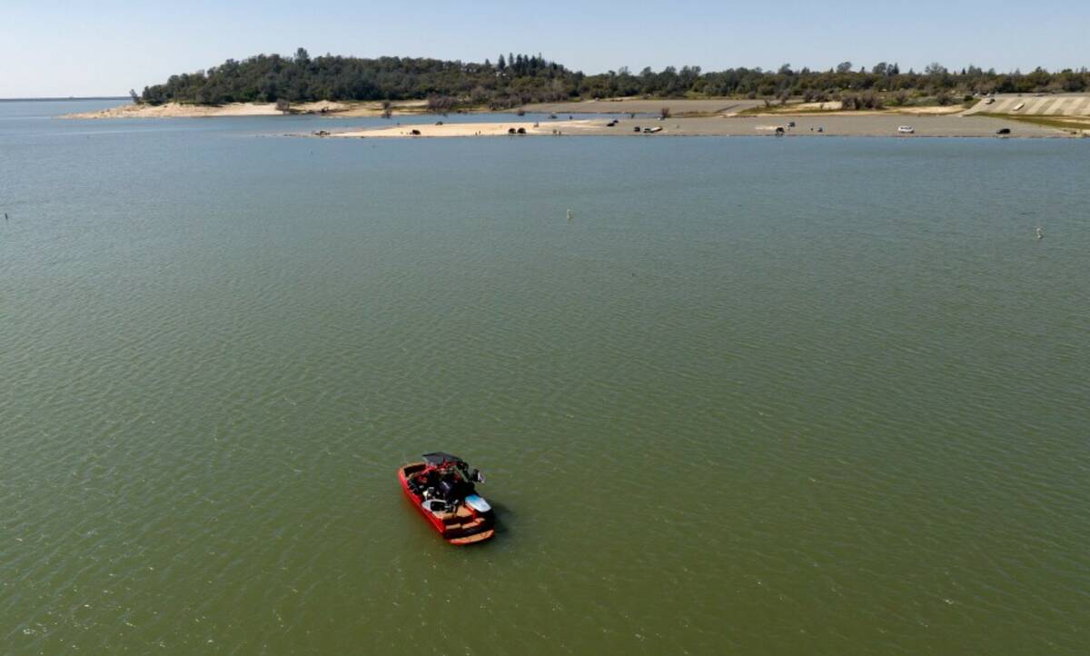 In an aerial view, a boat floats in the Granite Bay area of Folsom Lake, in Granite Bay, Calif. ...