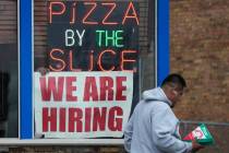 A hiring sign is displayed at a restaurant in Prospect Heights, Ill., Tuesday, April 4, 2023. O ...