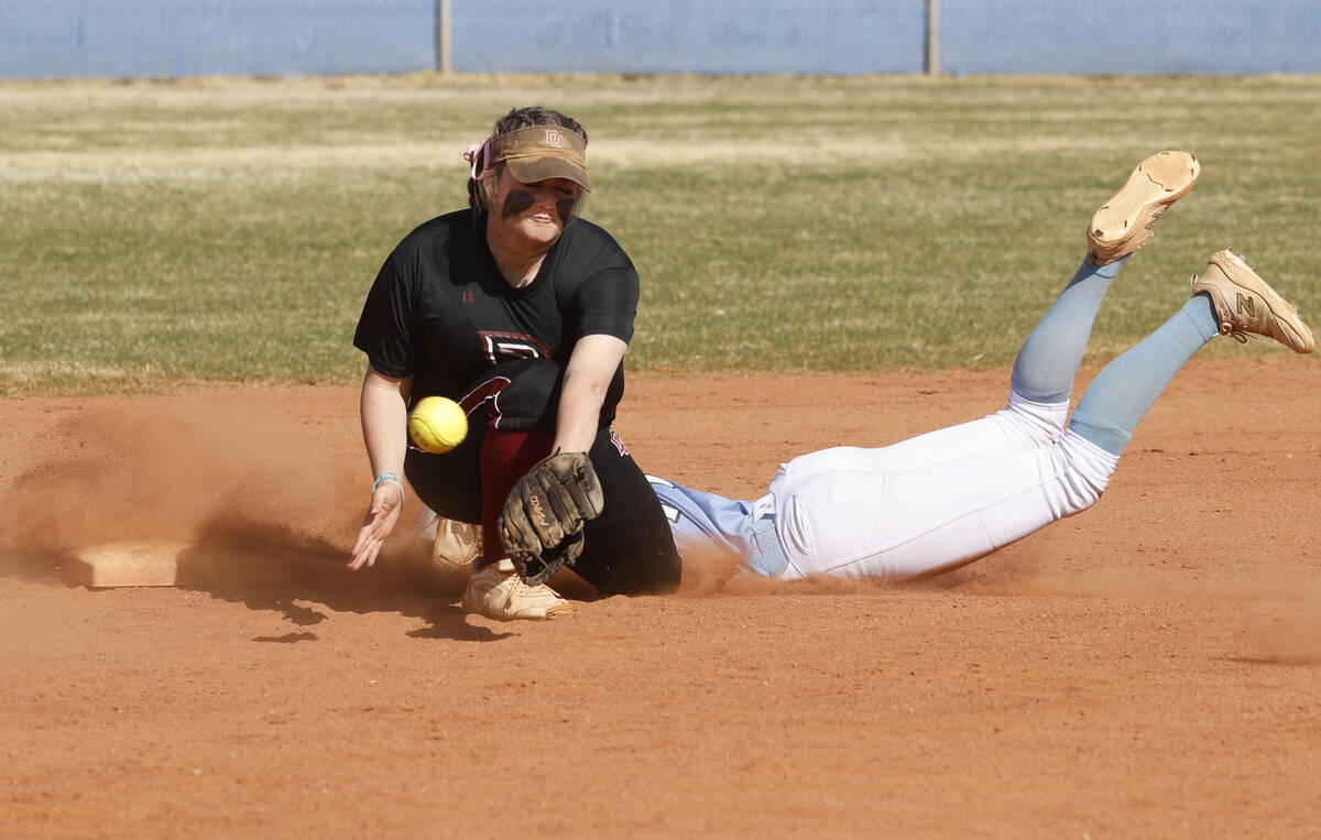 Desert Oasis' Veyda Simon (12) struggles to grab the ball as Centennial's Jill Halas (11) safel ...