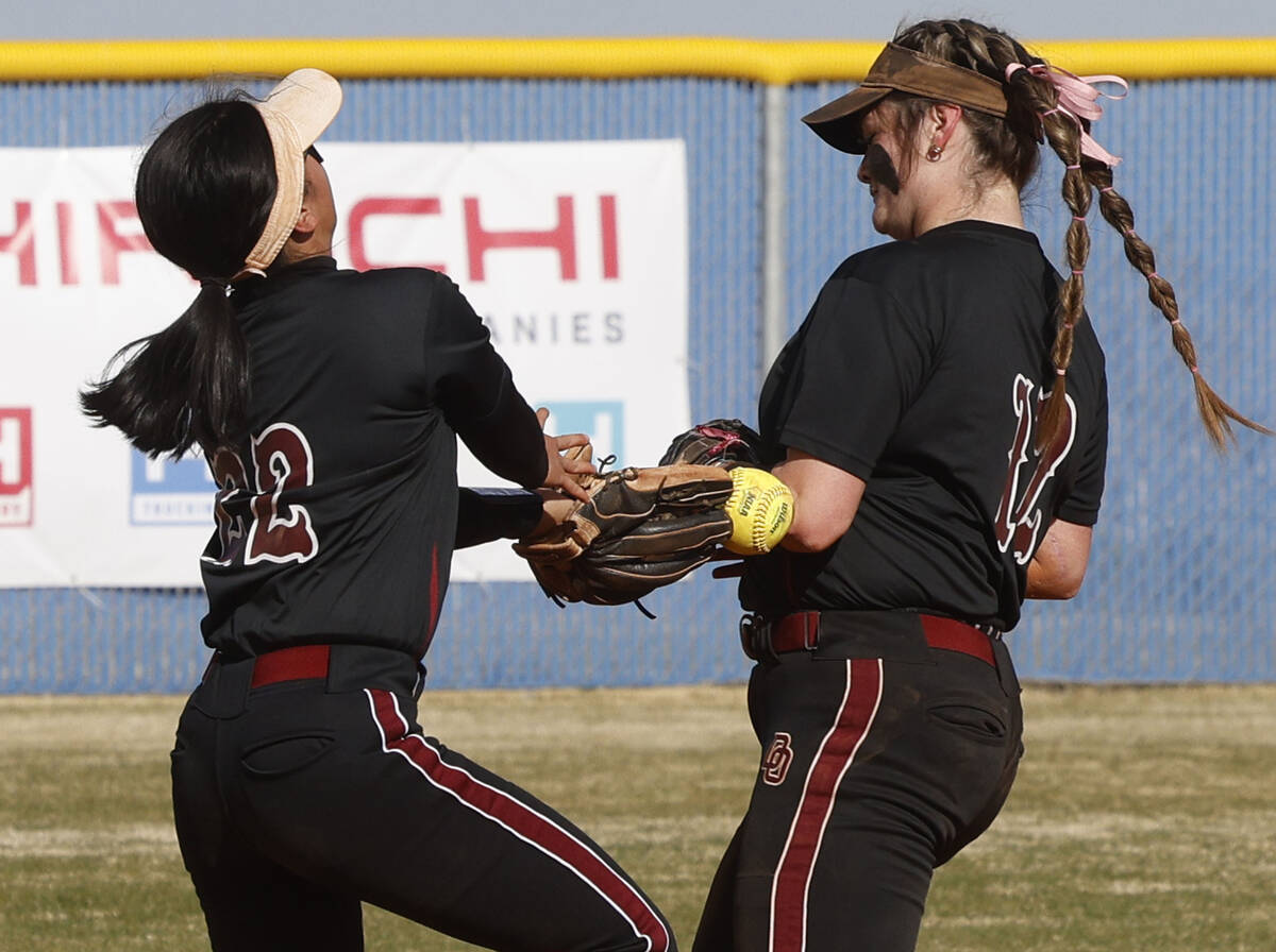 Desert Oasis' Allyson Ly (22) and Desert Oasis' Veyda Simon (12) drop the ball hit by Centennia ...