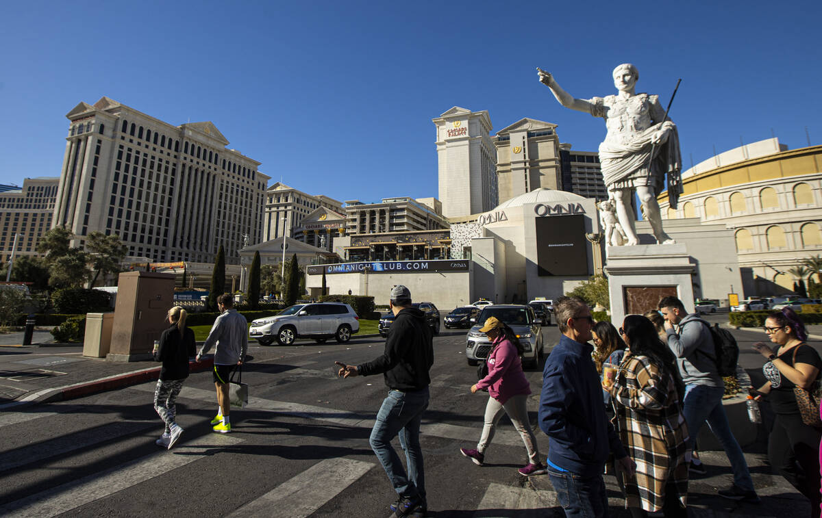 Pedestrians walk along the Las Vegas Strip outside of Caesars Palace on Thursday, Jan. 26, 2023 ...