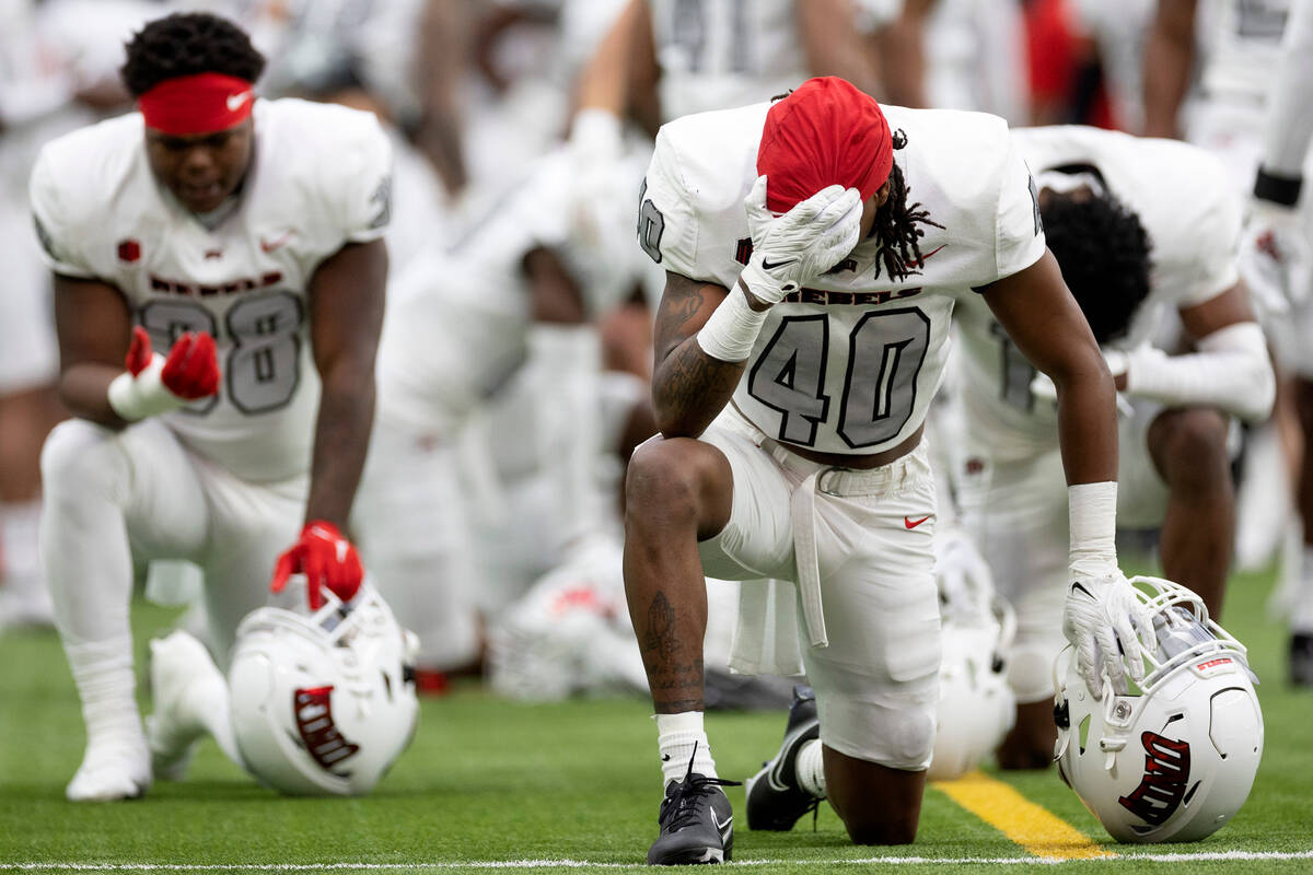 Defensive back Daego Albert (40) prays before the UNLV spring showcase game at Allegiant Stadiu ...