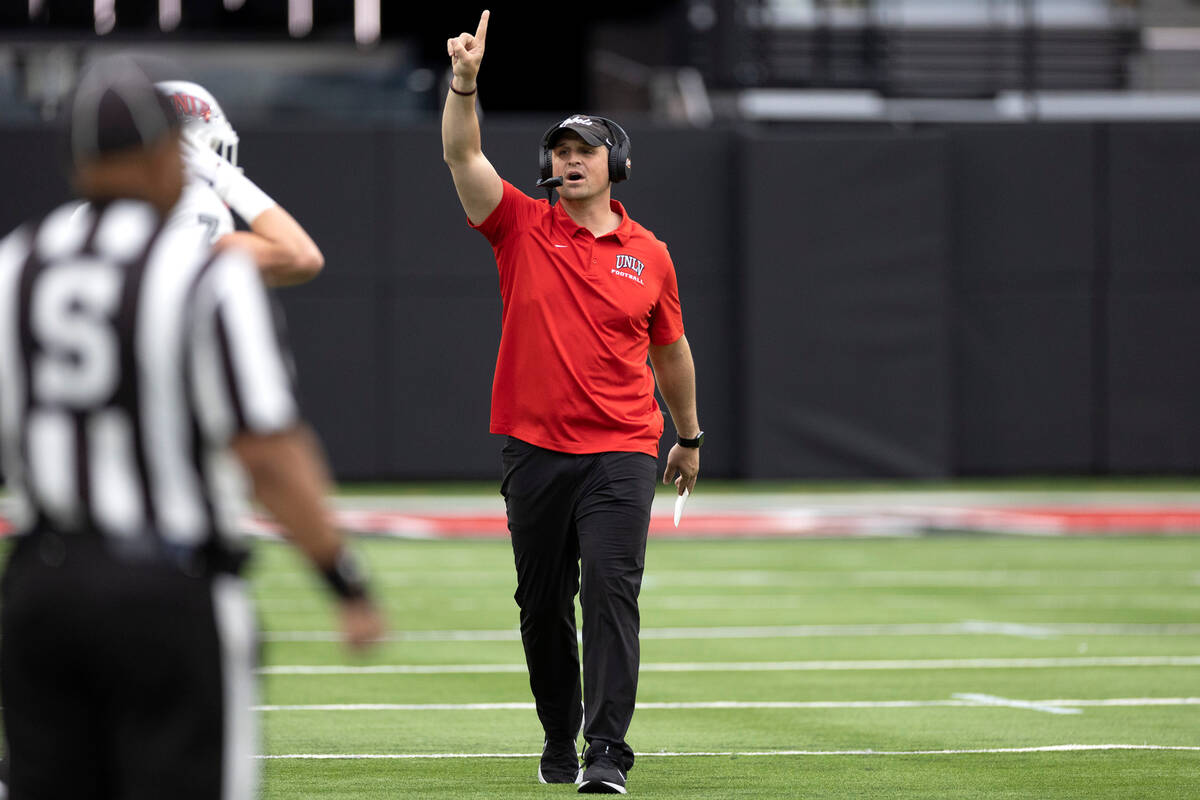 Defensive coordinator Mike Scherer coaches from the sidelines during the UNLV spring showcase g ...
