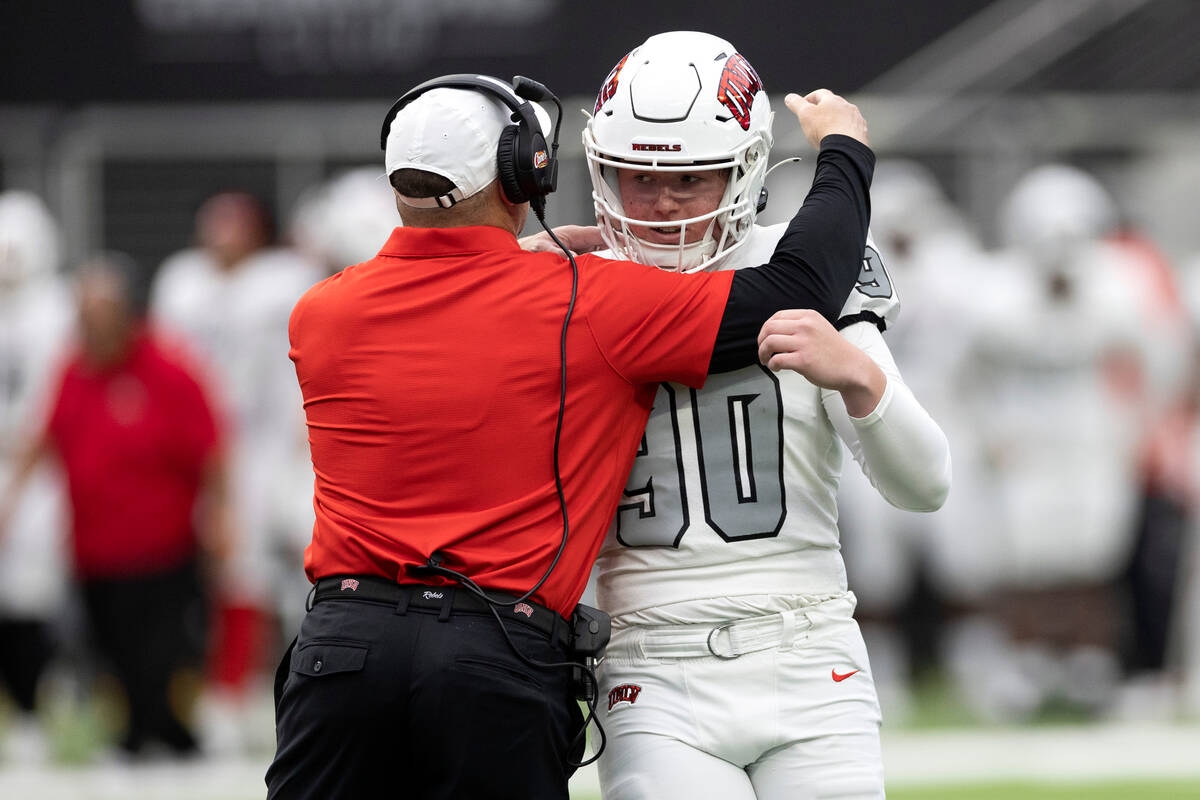 Head coach Barry Odom congratulates punter Marshall Nichols during the UNLV spring showcase gam ...