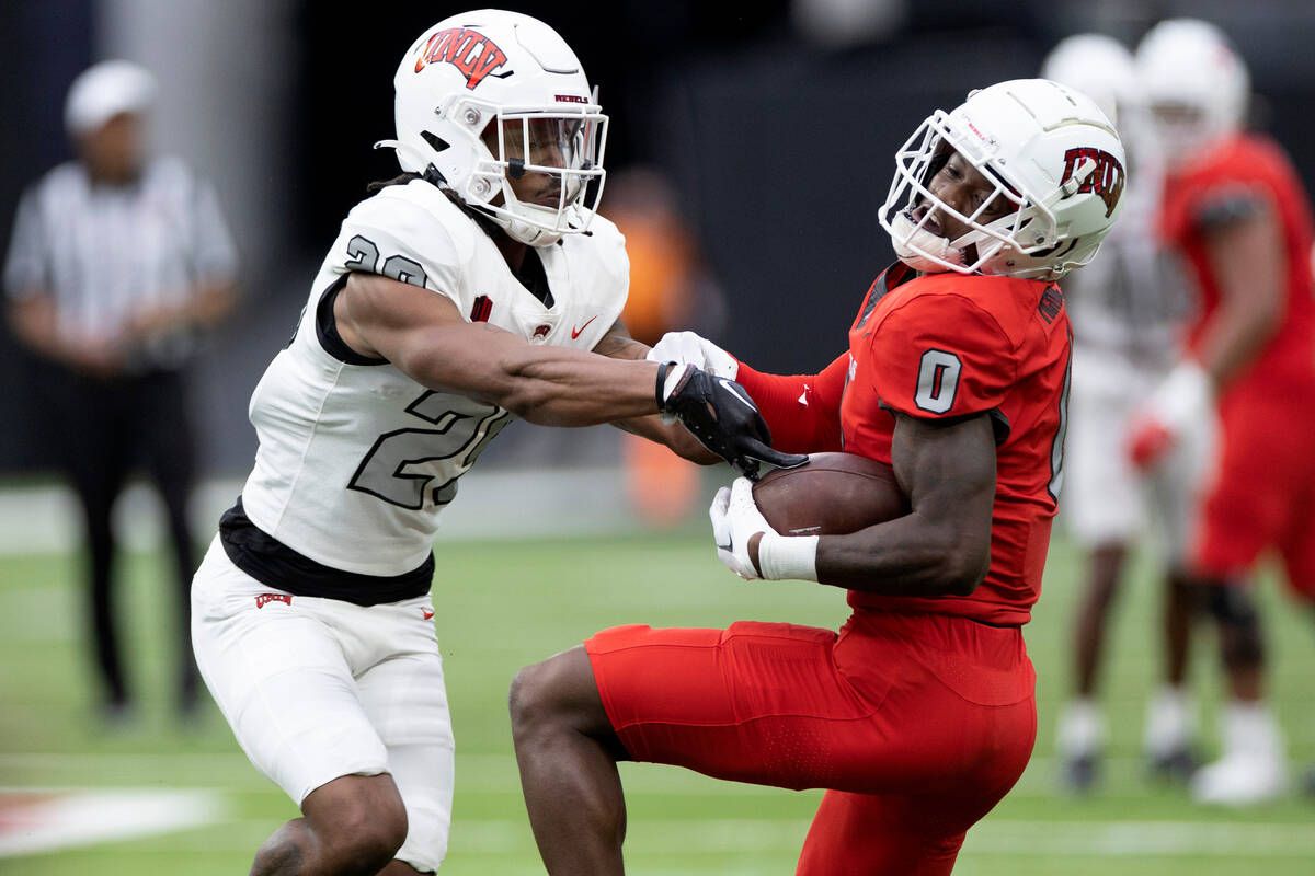 Wide receiver Senika McKie (0) carries the ball while defensive back Donyai Dixon (29) forces h ...
